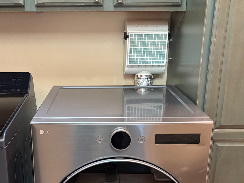 Laundry room with LG washer and dryer against gray cabinets.